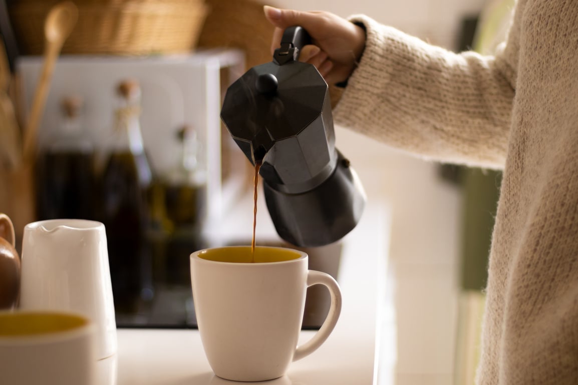 Person Pouring Coffee with an Italian Coffee Maker